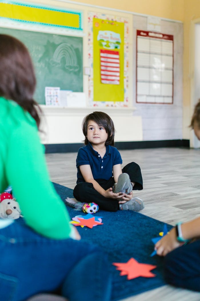Young children engaged in a learning activity in a classroom setting.